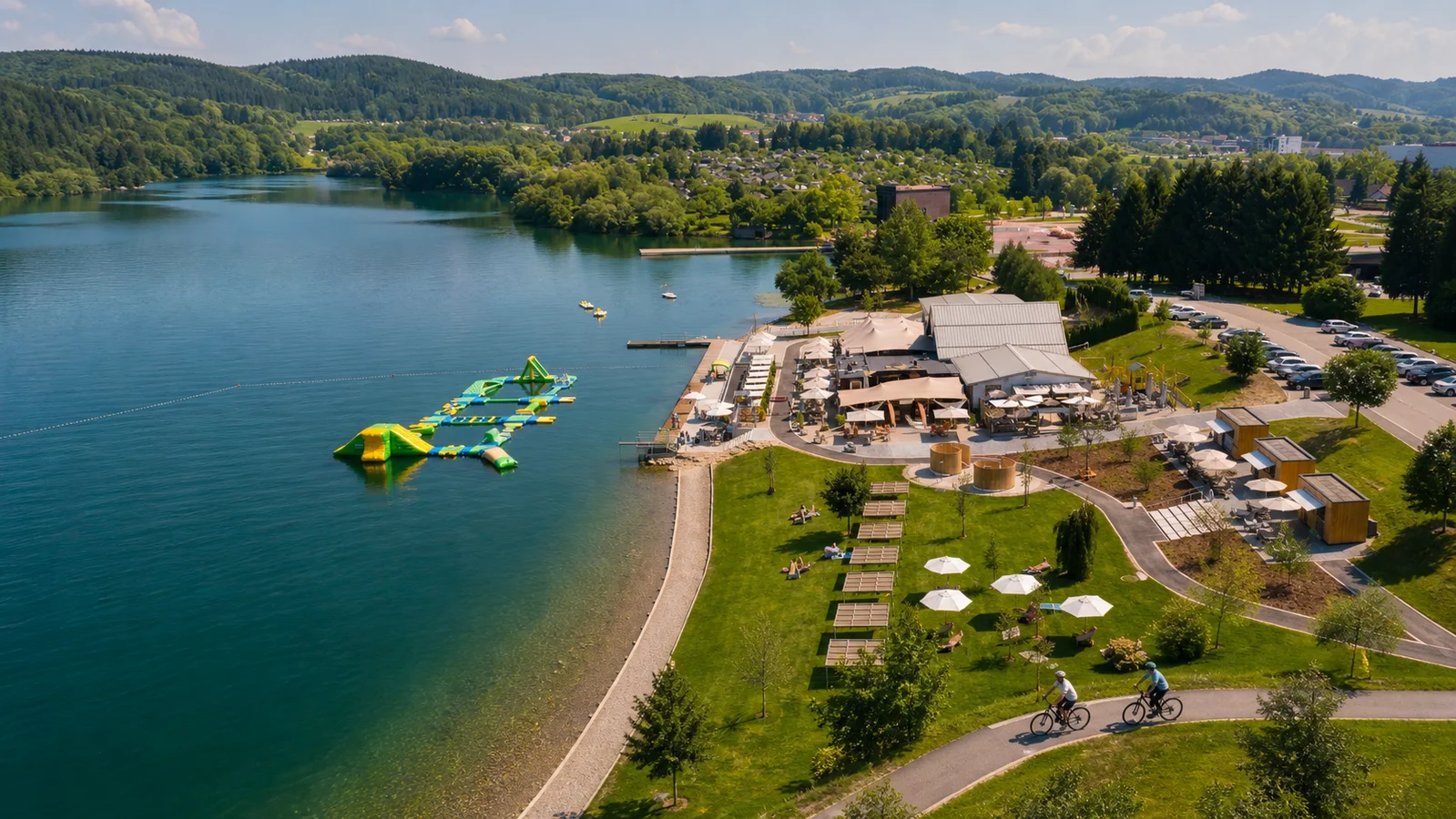 Lake Velenje, Velenje Beach and cyclists on a lakeside route